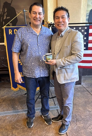Fillmore Rotary Club President John Garnica, pictured above, presents a Rotary mug to last weekâs guest speaker, Isaac Huang, Assistant Superintendent of the Fillmore Unified School District. Photo credit Martha Richardson.
