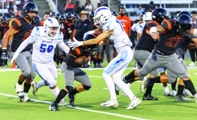 Pictured above are two Flashes Varsity players teaming up to take down a Chaffey player carrying the ball. 