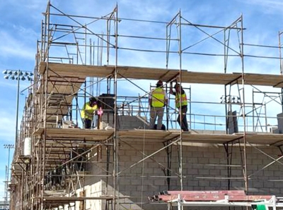 Above are crews welding the embeds at grid line 8 at the corners of the gym.