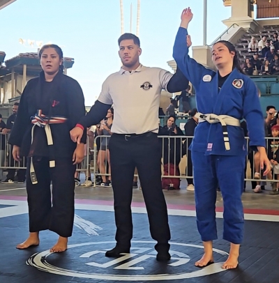 Pictured above is Perce’s Kenpo Karate’s Fillmore Jiu Jitsu Club’s Emma Lopez raising her hand after defeating her opponent. Photo credit by Emma Torres.