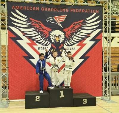Pictured are Fillmore’s Ethan Genest, Theo Zendejas and Arsen Arushanyan after getting their medals at the American Grappling Federation (AGF) Tournament held at Moorpark High School. Photo credit Michael Torres.