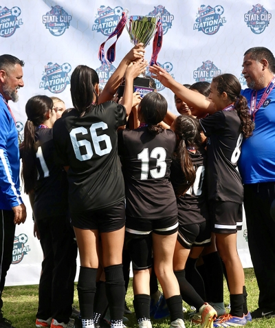 Above is the Fillmore’s California United FC 2013 Girls Team celebrating their championship victory after claiming the Cal South National Cup Title. Photo credit Erika Arana.