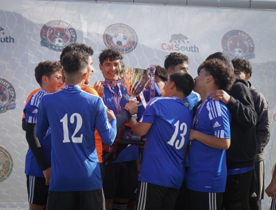 Last weekend Fillmore’s California United FC 2008 Boys Soccer was named Cal South State Champions for the first time ever. Above is the team celebrating after their victory, holding up their trophy. Photo credit Erika Arana. Full story begins on page 1.

Above is one of Fillmore’s California United FC 2008 Boys Soccer players as he tries to keep his opponent from taking the ball.
