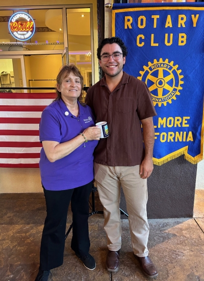 Pictured is Rotary Club of Fillmore President Anna Reilley presenting program speaker Jared Schieferle
with a Rotary mug. Photo credit Martha Richardson.
