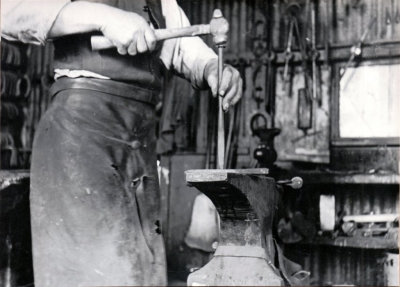 Andy Godinez preparing horseshoe, Rancho Sespe, 1920s.

