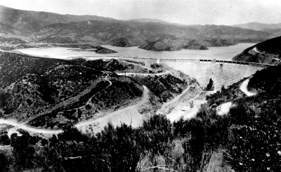 The St. Francis Dam in San Francisquito Canyon east of Castaic a few days before the collapse when it had just been filled to capacity. At three minutes to midnight on March 12th, 1928 the dam collapsed without warning causing a flood through the Santa Clara River Valley.