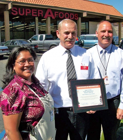 Super A Foods and Ventura County Public Health Department hosted the fifth annual Fruit and Veggie Fest in Fillmore last Thursday to help shoppers bridge the nutritional gap and improve their health by snacking smart. Pictured is Joann Torres, and Barry Fisher, Public Health Director who presented Marty Martinez, Super A Store Director with a recognition award for making fruits and vegetables available to the community at
affordable prices.