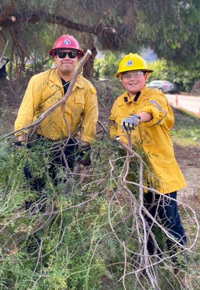 Piru Wildfire Liaison Michael Lopez with volunteer James Lopez helping clear out some vegetation.