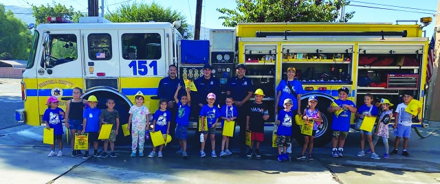 On Friday, October 5, 2024, the 1st grade students from Piru Elementary School took a field trip to the local fire station and went for a treat at a local restaurant after. Students were able to tour the station and try out some of the equipment and even leave with some of their own gear. Above are 1st graders and firefighters. Inset, the students at the restaurant in their new hats. Photos courtesy https://www.facebook.com/756397931999384/posts/128400044257246.