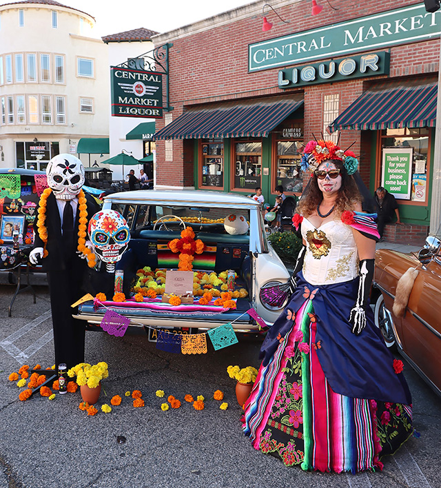 Fillmore’s downtown Central Avenue was really bustling on Sunday night, November 2nd, for Dia de los Muertos! The festivities started at 3pm and ran until 10pm. Decorative car displays lined the avenue as music and dance filled the air courtesy of Danza Aztecs, Love2 Dance Studio, Mariachi Los Leones, Cosmico, Danza Los Viejitos, Mariachi Los Rayos, La Sentencia Nortena, Danza Oaxaquenas, and Relicho Norteno. Great food and venders were available to keep the large crowd happy. Pictured is one of the colorful car displays, and an after-life guitar player. Mr. Bones sat holding a bunch of marigolds, waiting for his lost love to return. Photo credit Sebastian Ramirez.