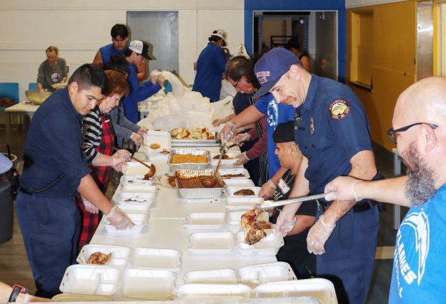On Sunday, December 8th, Fillmore Fire Department will host their annual Chicken Dinner Fundraiser to collect donations to for their annual Toy Drive. Above are Fillmore Fire Fighters and local volunteers who came out to help prepare to-go meals for last year’s dinner fundraiser. Photo credit Angel Esquivel.