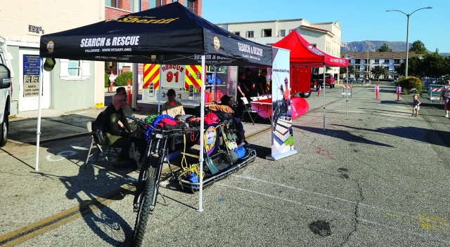 On Tuesday, August 6, 2024, from 5p.m. to 7p.m., in partnership the City of Fillmore, Fillmore Police Department and VC Sheriff’s Office hosted “National Night Out”, an annual crime prevention event and community-building campaign promoting police-community partnerships and neighborhood camaraderie that makes our neighborhoods safer all year round. Crumble Cookie and Fillmore Starbucks were kind enough to donate snacks for this event. Pictured inset (l-r) are community members Marissa Rodriguez, Sheriff Jim Fryhoff, Sergeant Foote and Fillmore Fire Chief Keith Gurrola enjoying the event.