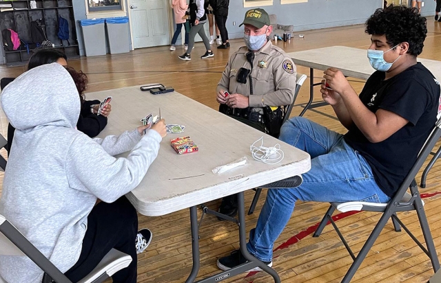 On Friday, April 30th, Fillmore School Resource Officer Jonathan Schnereger stopped by the SCV Fillmore Boys & Girls Club to play a game of UNO with the teens. Thank you for your daily visits with our kids and being a true example of community policing! Courtesy SCV Boys & Girls Club Facebook page.