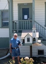 Pictured is Jack Stethem, who has made many Little Libraries for the community, standing next to the library which is a replica of the historical church that was erected in 1898.