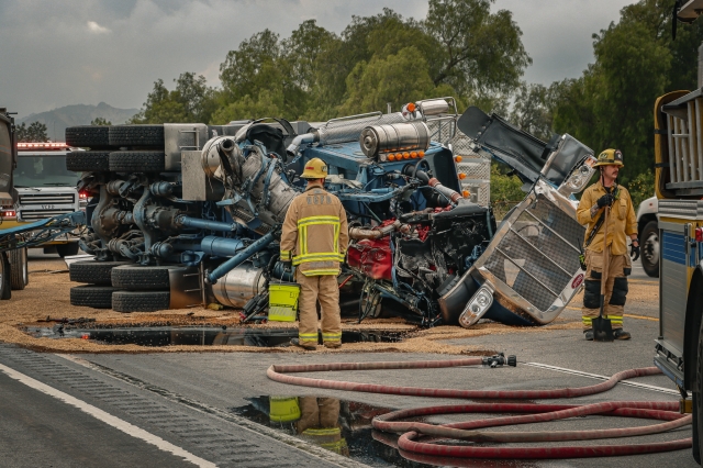 On Friday, May 24, at 9:12am, Ventura County Fire Department, AMR Paramedics, and California Highway Patrol were dispatched to a reported traffic collision westbound SR126 near Hopper Canyon Road. A semi-tractor trailer loaded with sand rear ended a truck trailer and overturned, spilling its load onto the roadway. Arriving firefighters reported that both occupants of the trucks were uninjured. Both westbound lanes were closed for more than two hours while the debris was cleared. Photo credit Angel Esquivel-Firephoto_91.