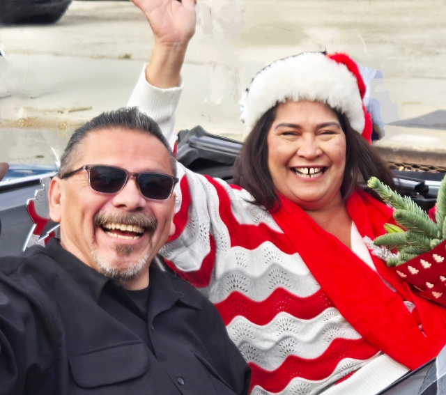Pictured are the Piru Christmas Parade Grand Marshals, longtime residents Paul and Laura Ortega, waving to the crowd. Below is the Fillmore High Marching and Mariachi Band.