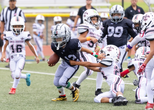 Pictured above is Fillmore Raiders Mighty Mites Black #12 trying to break free from a Santa Barbara Saints player last Saturday. Final score Raiders 0-Santa Barbara 12. Photo credit Crystal Gurrola.