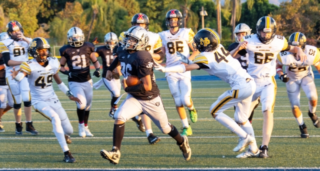 Pictured above is Fillmore Raiders Seniors Black #36 last Saturday, making his way down the field, dodging the Newbury Park Steelers heading for the endzone. Final score Raiders 20 – Steelers 18. Photo credit Crystal Gurrola.