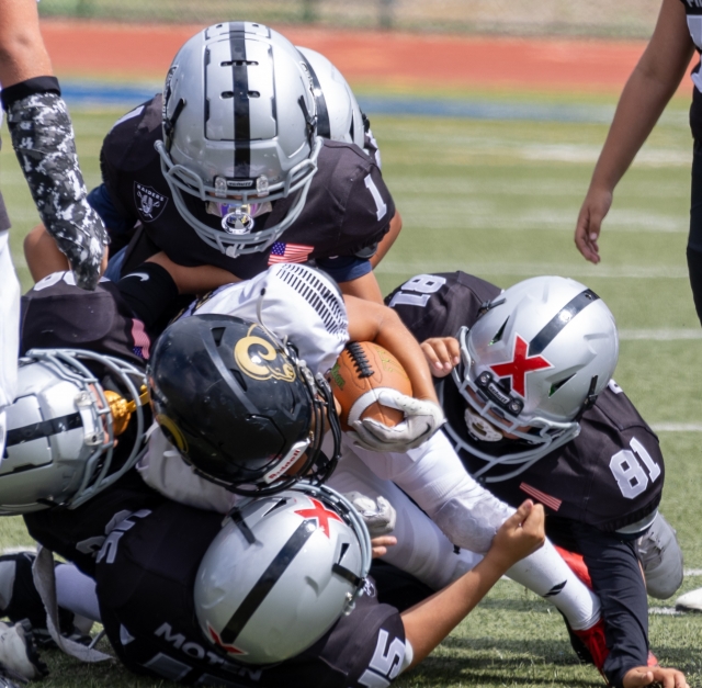 Raiders Freshman team up to dogpile on a Calabasas player to keep him from advancing. Photo credit Crystal Gurrola.
