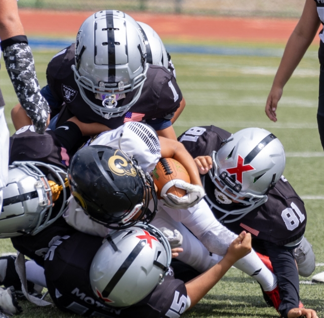 Raiders Freshman team up to dogpile on a Calabasas player to keep him from advancing. Photo credit Crystal Gurrola. 