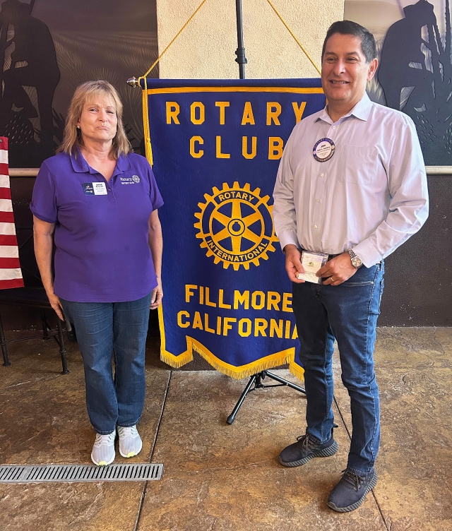 At last week’s Fillmore Rotary Club meeting President Anna Reilley presented a Rotarian of the Month pin to John Garnica for all he does for the club. Photo credit Martha Richardson.