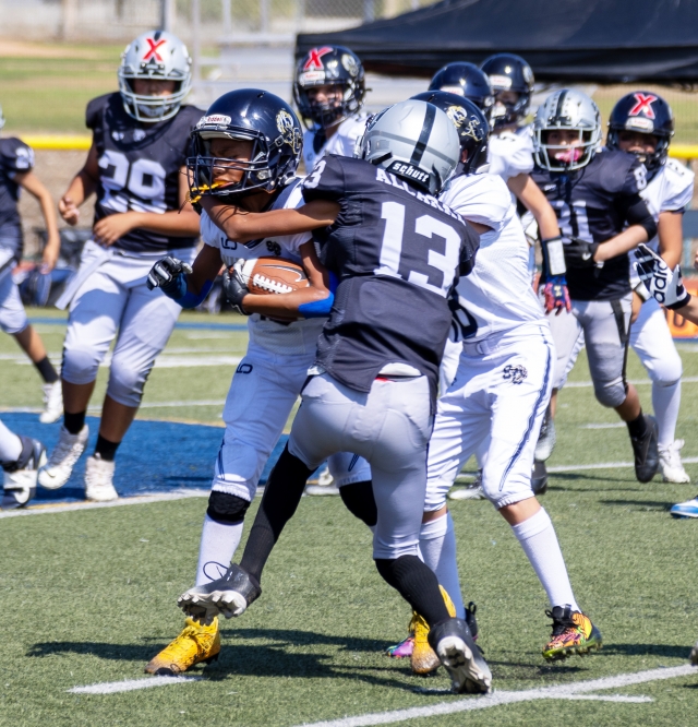 Pictured is Raiders Sophomores Silver #13 taking down an SC player stopping him dead in his tracks. Final score Raiders 8 – SC – 0. Photo credit Crystal Gurrola.