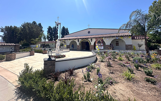 Saint Francis of Assisi Roman Catholic Church held their Centenary Celebration on Sunday, July 19, 2026. The church also revealed its new “California Mission” look, pictured right. The building was dedicated on February 1, 1976. In 1914 Fillmore was a mission of St. Sebastian Parish in Santa Paula, ten miles west of Fillmore. The priests from Santa Paula offered Holy Mass in backyards and classrooms and helped the small but growing number of Catholics raise funds through fiestas, bazaars and raffles. In 1924 they petitioned Bishop John J. Cantwell to supply a priest and church for Fillmore. The bishop had a great concern for the spiritual welfare of his people. Over a period of 30 years, Bishop Cantwell created 50 parishes and missions as the seventh Bishop of the Diocese of Los Angeles and San Diego. In 1926, by God’s grace, the tiny church located at the corner of First Street and Central Avenue in Fillmore was one of them, serving the community as a beacon of faith. Numerous baptisms, weddings, funerals, confirmations and first communions were celebrated there, as well as daily and Sunday Mass for the growing number of the devout. Photo credit Gazette staff.