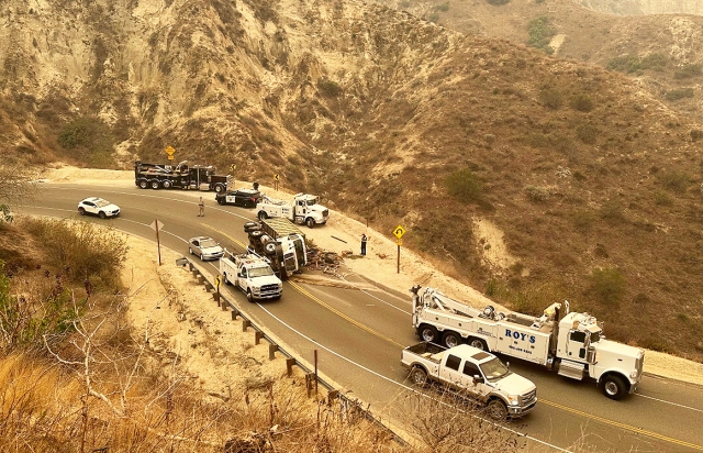 On Wednesday, January 22, 2025, at approximately 12:00pm, a 3-axel, 14-wheel dump truck overturned on Grimes Canyon, closing the road for about three hours. CHP was on-scene while the truck was righted and removed. Photo credit Karen Moureaux of All Dogs Rule.