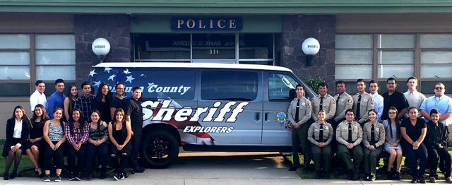 Explorers pose with their new van which was purchased to help transport the young men and women, 14 to 21, who have an interest in learning more about a career in Law Enforcement, to community events, meetings, and training events, both within the county and out of state.