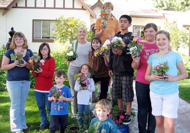 Getting ready for the Fillmore Flower Show! Bardsdale 4-H gardening project members proudly show their flower arrangements with teacher Janet Foy. Thanks to Janet for showing the kids several techniques to create artistic floral displays. They practiced now so they can be ready for the Flower Show coming on Saturday, April 10th and 11th.