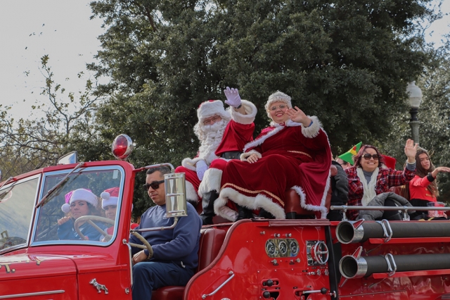 Santa and Mrs. Claus waved to the crowd while riding in a vintage fire truck.