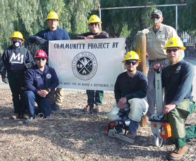 Above are volunteers who helped mitigate flammable fuel, a pepper tree fire hazard, near residents’ homes in Piru.