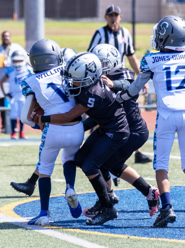 Pictured above is Fillmore Raiders Freshmen #5 trying to take down a Camarillo stinger player. Final score Raiders 8 – Camarillo 30. Photo credit Crystal Gurrola.