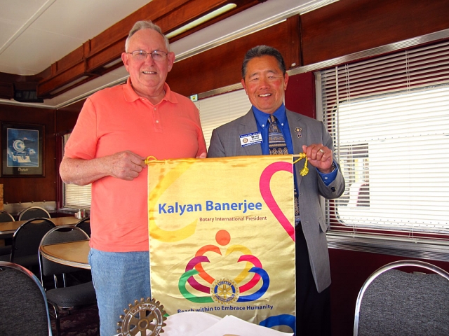 Wade Nomura, (R) District Governor, presented the Rotary flag to Don Downey (L), of Rotary-noontime.