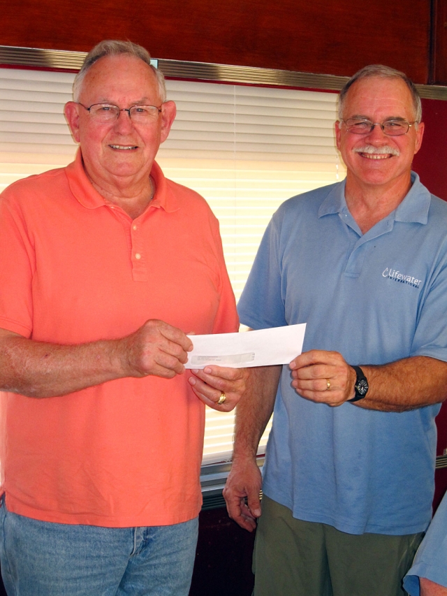 Don Downey, of Rotary Noontime, presented a check to Rod Thompson, of Lifewater, to continue pumping wells around the world.