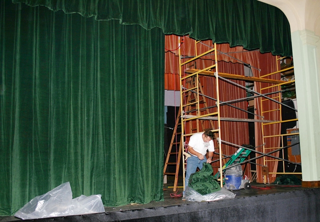 John Foy hanging the new stage curtains in the Sespe Auditorium.
