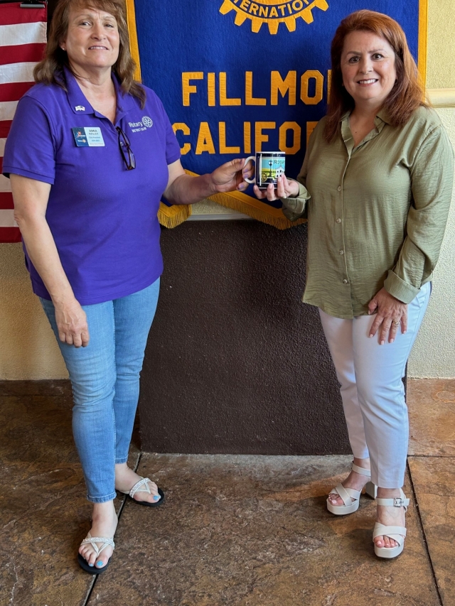 Last week, the Fillmore Rotary speaker was Theresa Robledo (far right) from Diamond Realty. She has been a licensed real estate agent since 2005 and a licensed broker since 2010. She Theresa discussed real estate in Fillmore and surrounding areas. She said at the present time there are only 20 properties available and there have been 126 closings. The average price for a home in Fillmore is around $700,000. She also mentioned that the current rent for a three bedroom, two bath home in Fillmore is about $3,000 per month. If you are interested and want more information Theresa can be reached at 805-524-2121 or 316 Central Avenue in Fillmore. Pictured is Rotary President Anna Reilley presenting speaker Theresa Robledo from Diamond Realty with a Rotary mug. Photo credit Martha Richardson.