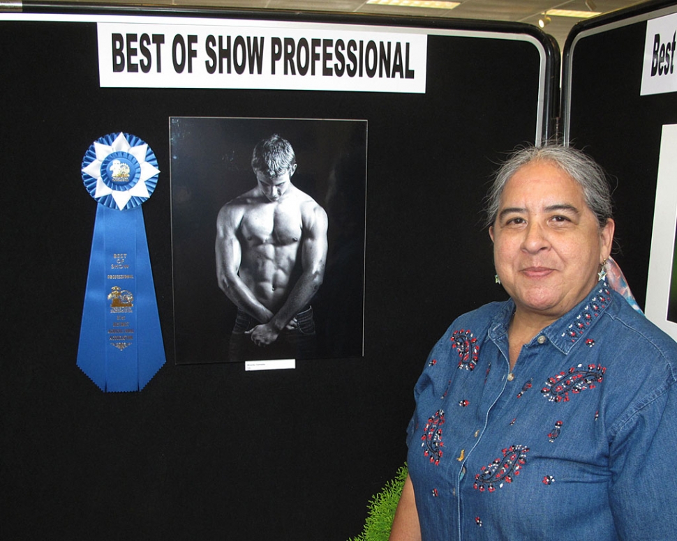 Carmelita Miranda with her portrait of Christian Conaway.