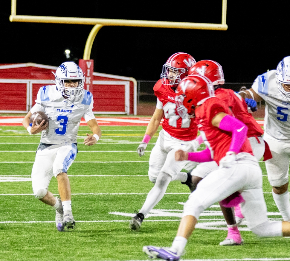 Pictured above is FHS Varsity #3 looking ahead to find a way past the Hueneme defense to gain some yards for the Flashes. Photo credit Crystal Gurrola. 