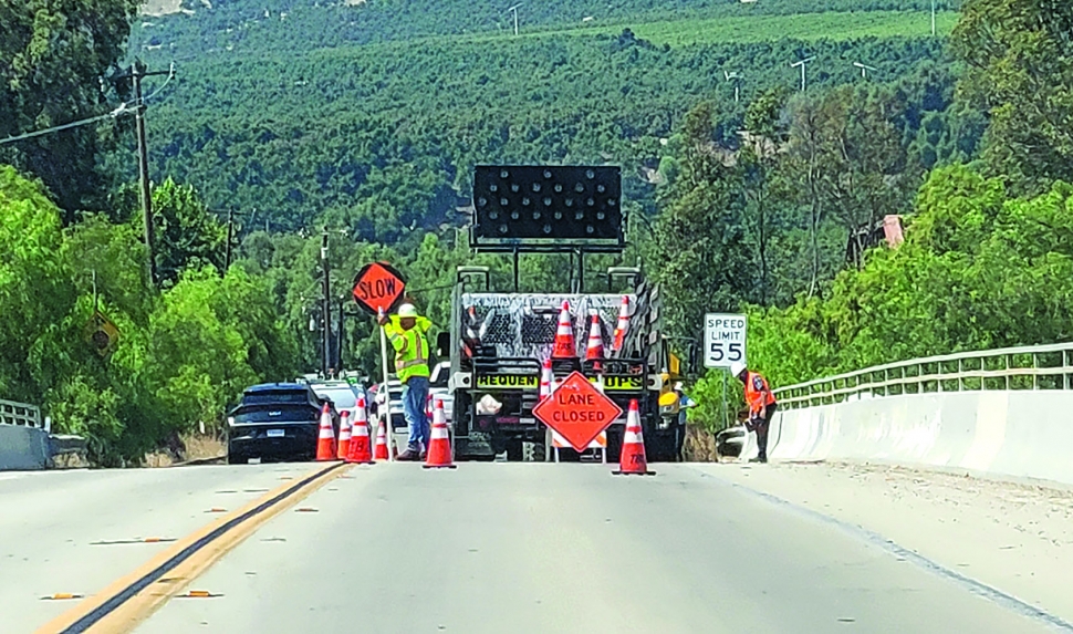 On Friday, September 13, 2024, traffic was delayed for work on Old Telegraph Road which was closed down to one lane due to the Ventura County Transportation Commission doing emergency repairs on the embankment along the Sespe Creek. Photo credit Angel Esquivel. Inset photo Gazette staff.