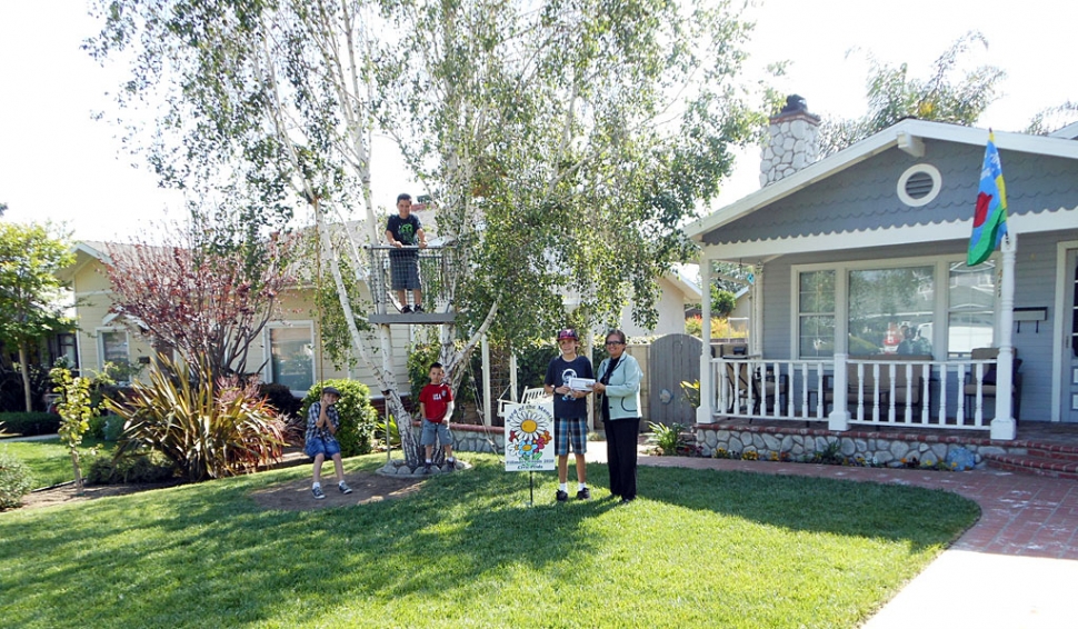 Ari Larson, representing Fillmore Civic Pride/Vision 2020, Scott and Matthew Van De Mheen and neighbors Adrian and Isaiah Hernandez) stand in Mike and Deirdre Van De Mheen’s yard.