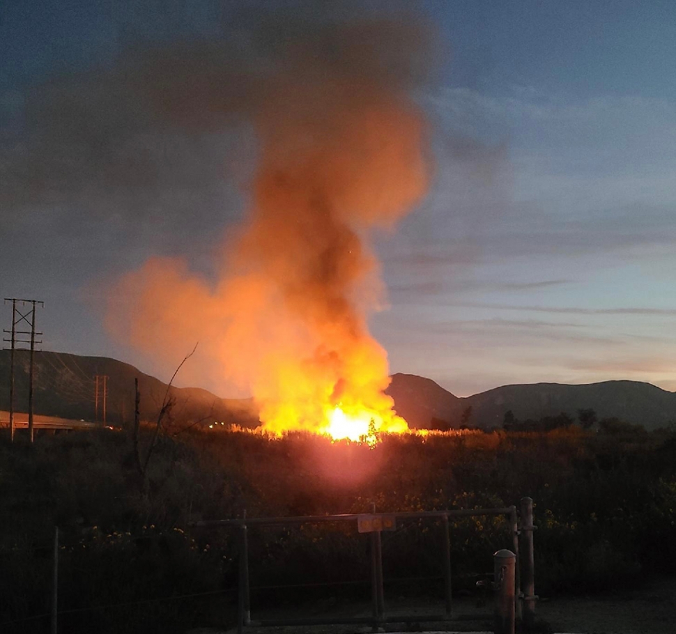 On Wednesday, March 16th, 2022, at 7:13pm, Ventura County Fire Department and Fillmore City Fire were dispatched to a large brush fire in the Santa Clara River bottom, just west of the A Street Bridge (Chambersburg Road/23) where homeless camps are entrenched. According to fire department radio traffic the fire burned 1.7 acres. No injuries were reported; cause remains under investigation. Fillmore Sheriff’s Department and CHP closed both lanes of the A Street Bridge for an hour. An ambulance was requested as a precaution due to the homeless encampment. The Ventura County Fire/Sheriff Copter took part in the firefight along with hand crews and brush fire engines. Firefighters established a wet line around the fire and halted forward progress before 8:20 p.m. Photo credit Gazette Staff. Information credit Angel Esquivel-AE News.