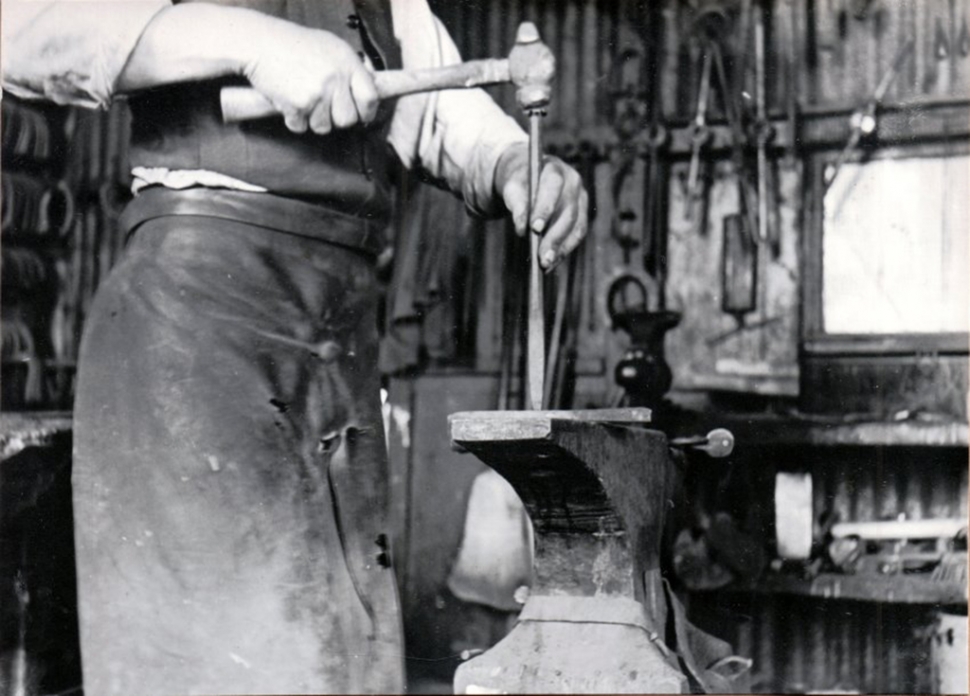 Andy Godinez preparing horseshoe, Rancho Sespe, 1920s.