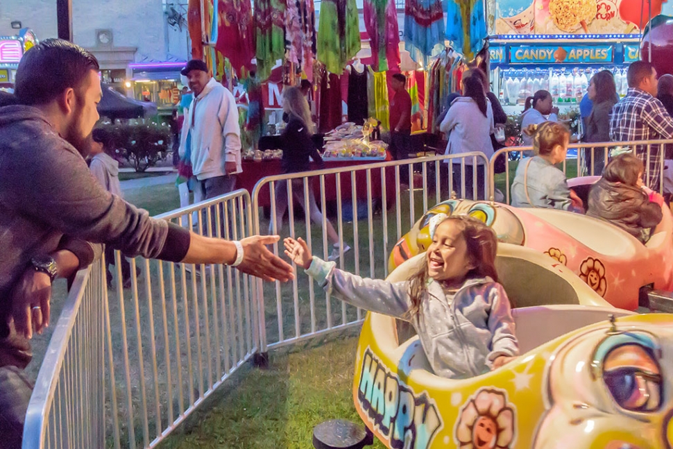 Photo of the Week "Girl and father both enjoying the experience" by Bob Crum. Photo data: Camera Canon 7D MKII Manual mode, ISO 10,000, Tamron 16-300mm lens @ 28mm, aperture f/11, shutter speed 1/125 second.