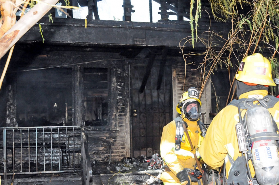 A house fire in the 4000 block of Market St. in Piru started about 1:40 p.m. The structure was completely engulfed in flames when the Ventura County and Fillmore Fire Departments arrived. Exploding small arms ammunition slowed firefighting activity for a short time. Approximately seven retired L.A. firefighters, who were working on a nearby Habitat for Humanity project, were first to assist at the scene, see photo page 2. Complicating the situation was a live power line which fell across the access road. No injuries were reported. Neither the cause nor the damage estimate were available at press time.